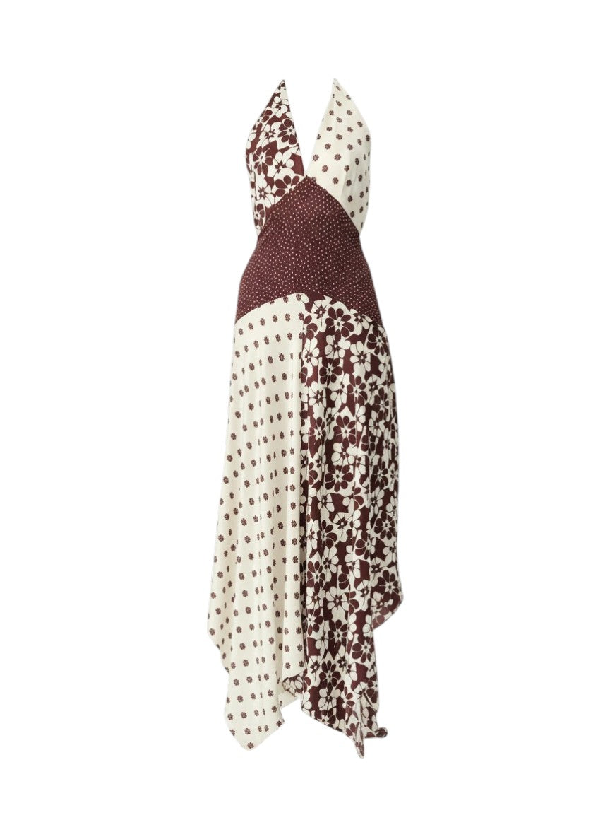 A halter-neck maxi dress with a patchwork design featuring cream and brown polka dot patterns and a solid dark brown textured panel, shown against a plain white background.