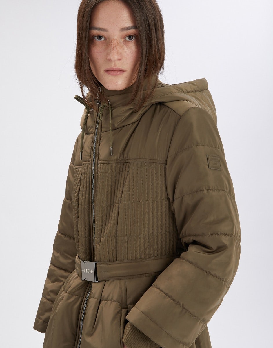 Person wearing a brown puffer jacket on a white background