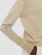 Close-up of beige fabric with stitching detail on a white background