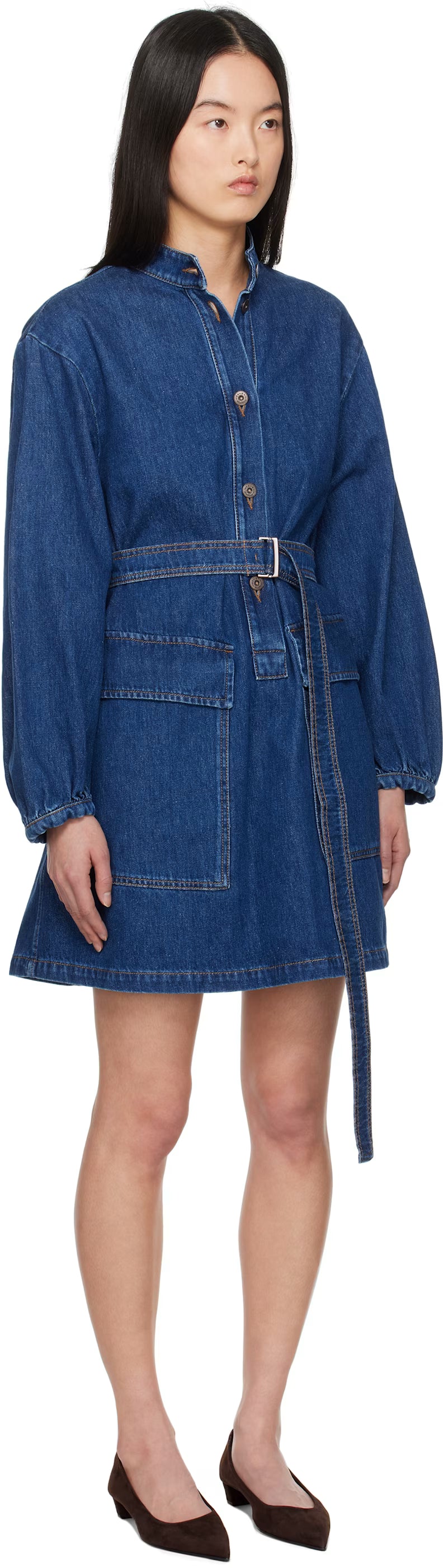 Woman wearing a blue denim dress on a white background