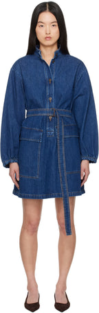 Woman wearing a blue denim dress on a white background