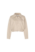 A cropped beige jacket with a collar, front zipper, and gathered elastic hem, shown on a plain white background.