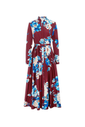 A long-sleeved maxi dress with a high collar and a matching waist tie, featuring a bold floral print in blue, cream, and white over a deep burgundy base, shown against a plain white background.