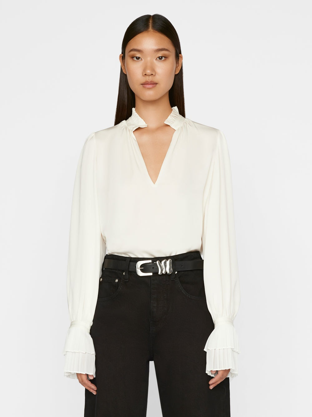 This FRAME &nbsp;v-neck top features pleats at the collar and cuffs, for a romantic look that transforms high-waisted jeans into a striking date night outfit, but also works at the office styled under a blazer.